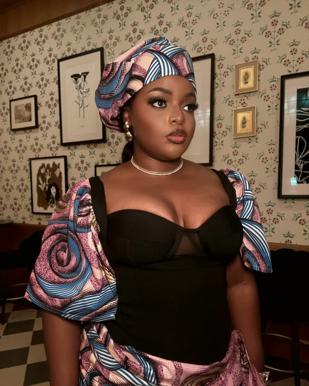 Bibi in a pink and blue kitenge top with a matching headwrap